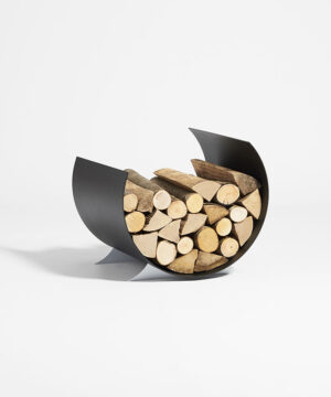 Grande Luuna log holder for fireplace with a large load of wood with a modern design and circular shape reminiscent of the Moon